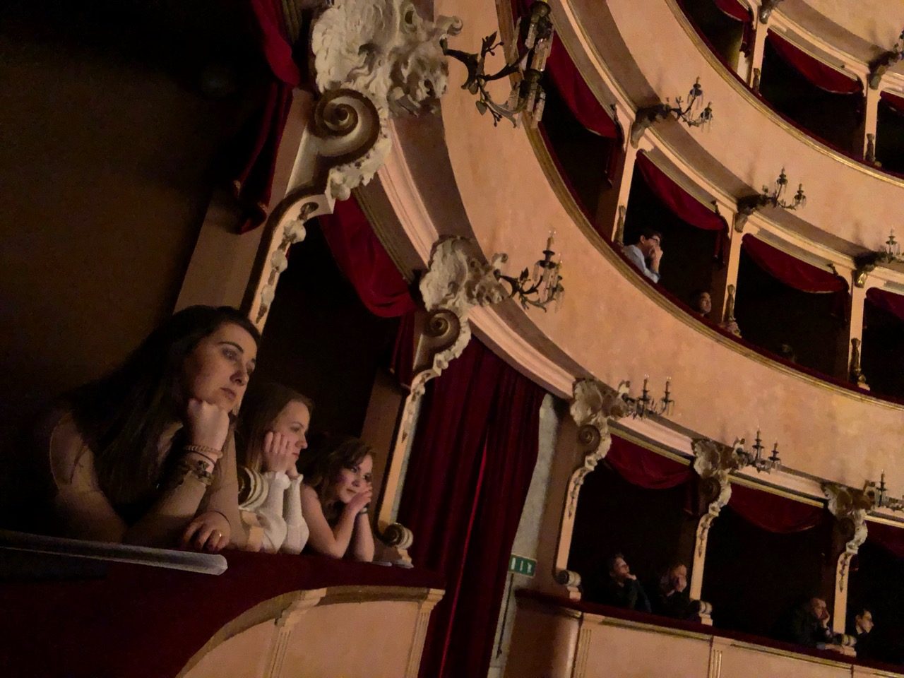 Students sit in the balcony of a theater.