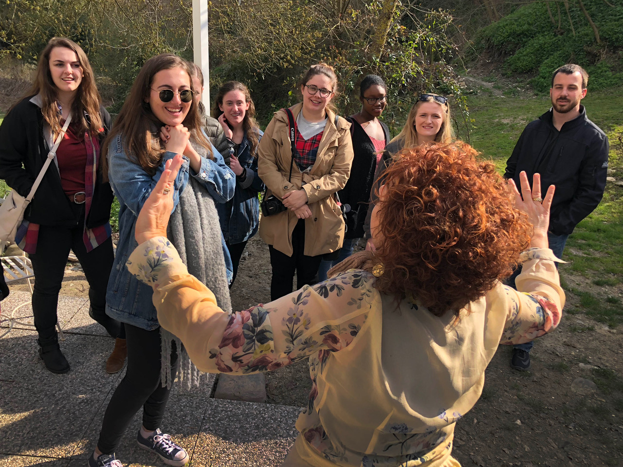 Students watch as a woman talks and gestures.