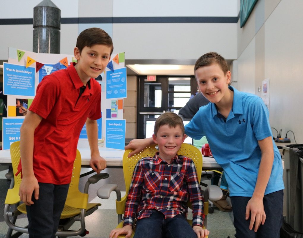 Carson (left) and McClain (right) Crigger, with Maddox, their younger brother, presenting their project, Speech Helper 2.0.