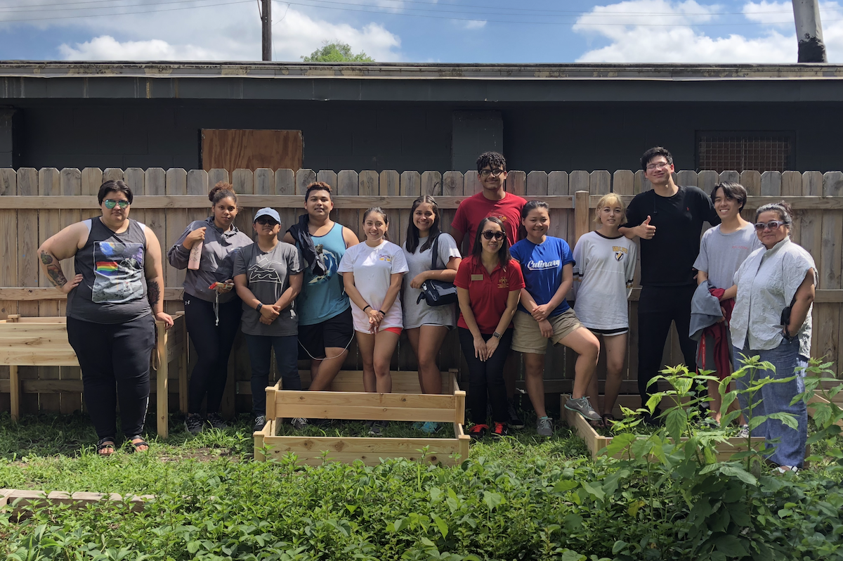 Students stand in a garden in Des Moines.