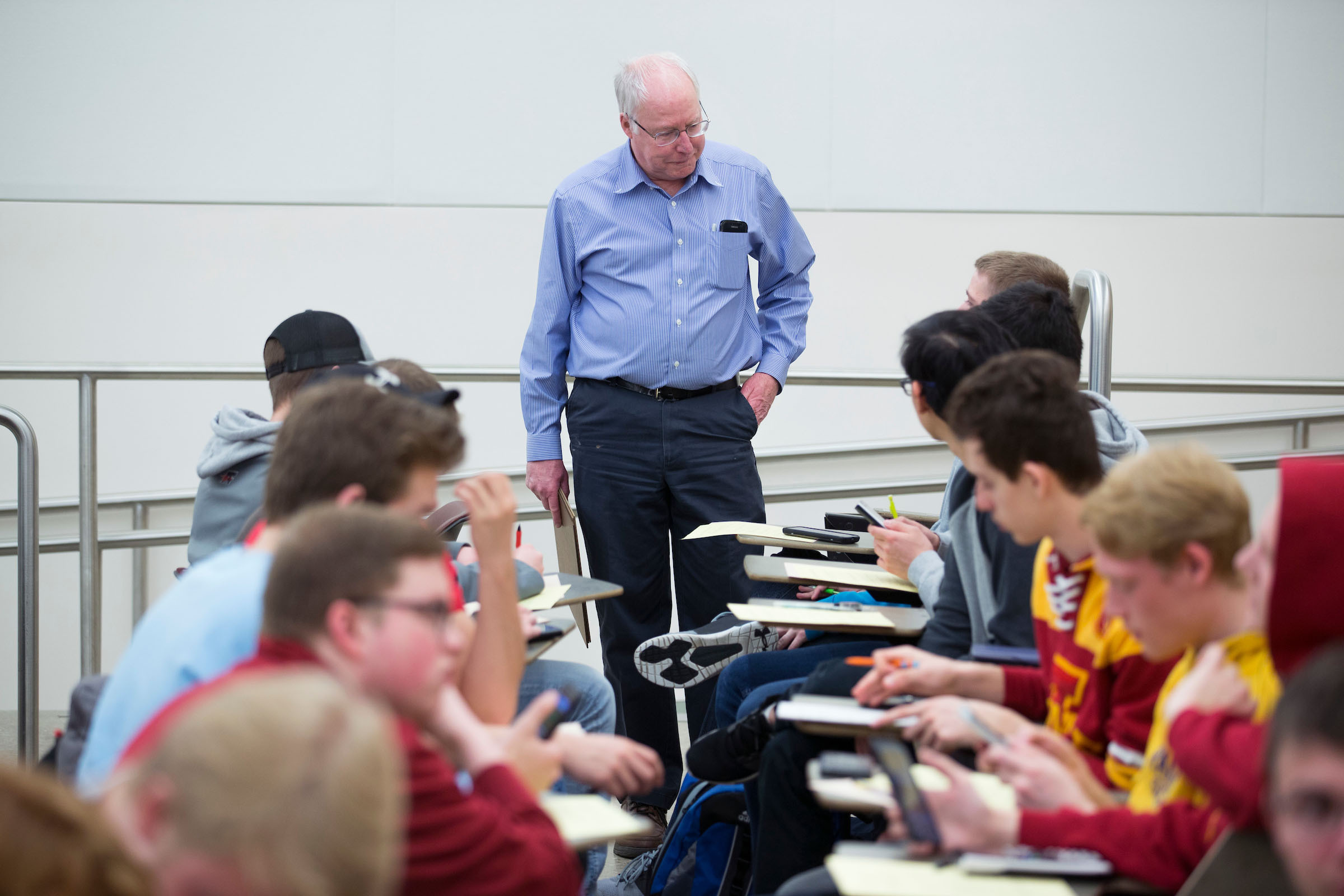 Elgin Johnston talks with students as they work on calculus problems in class. Photo by Christopher Gannon.