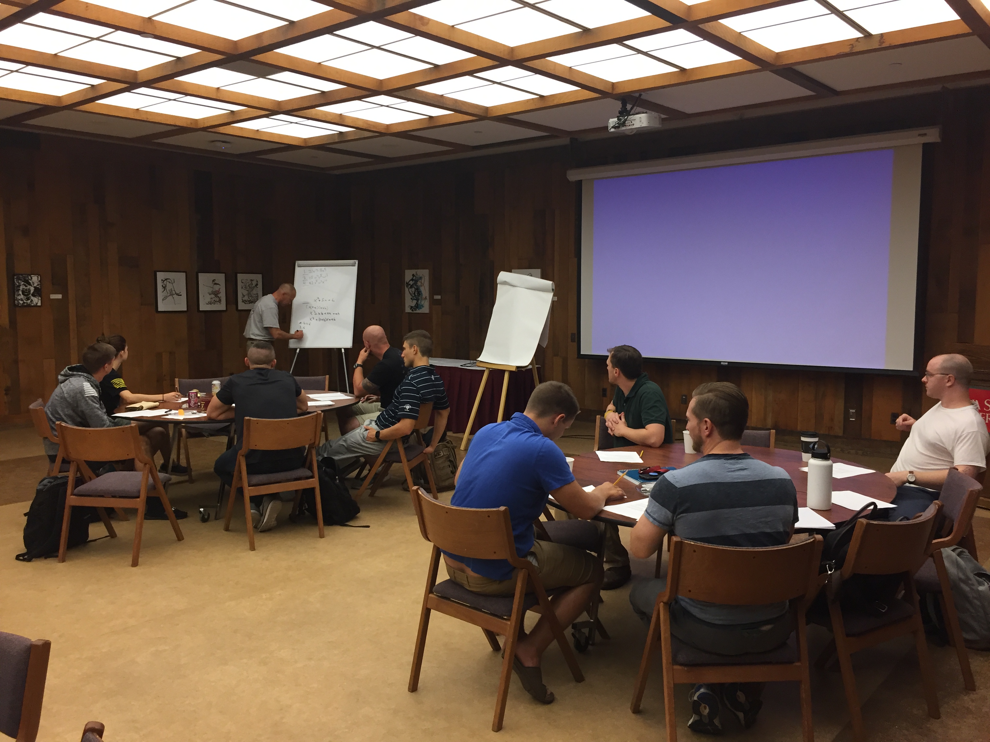 Students sitting at tables in a room.