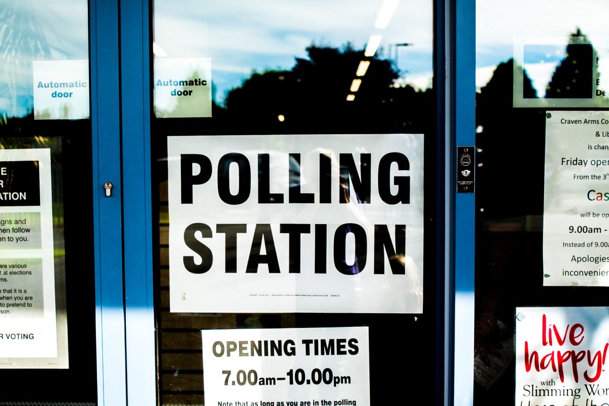 Photo by Photo of glass doors with sign that reads "Polling Station" attached. Photo by Elliott Stallion on Unsplash