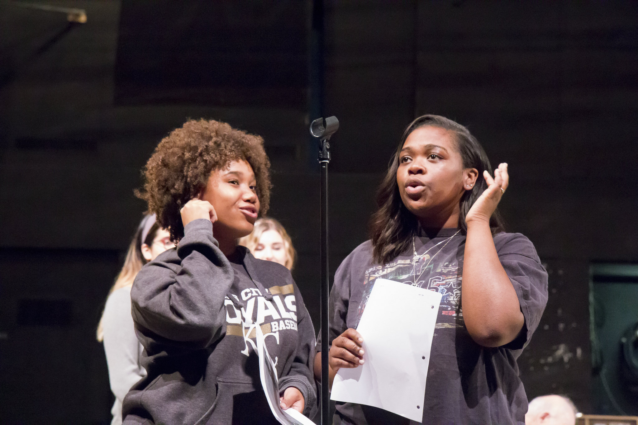 Two students sing on stage.