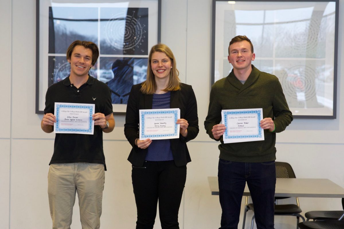 Three students hold certificates after winning the LAS Pitch Competition.