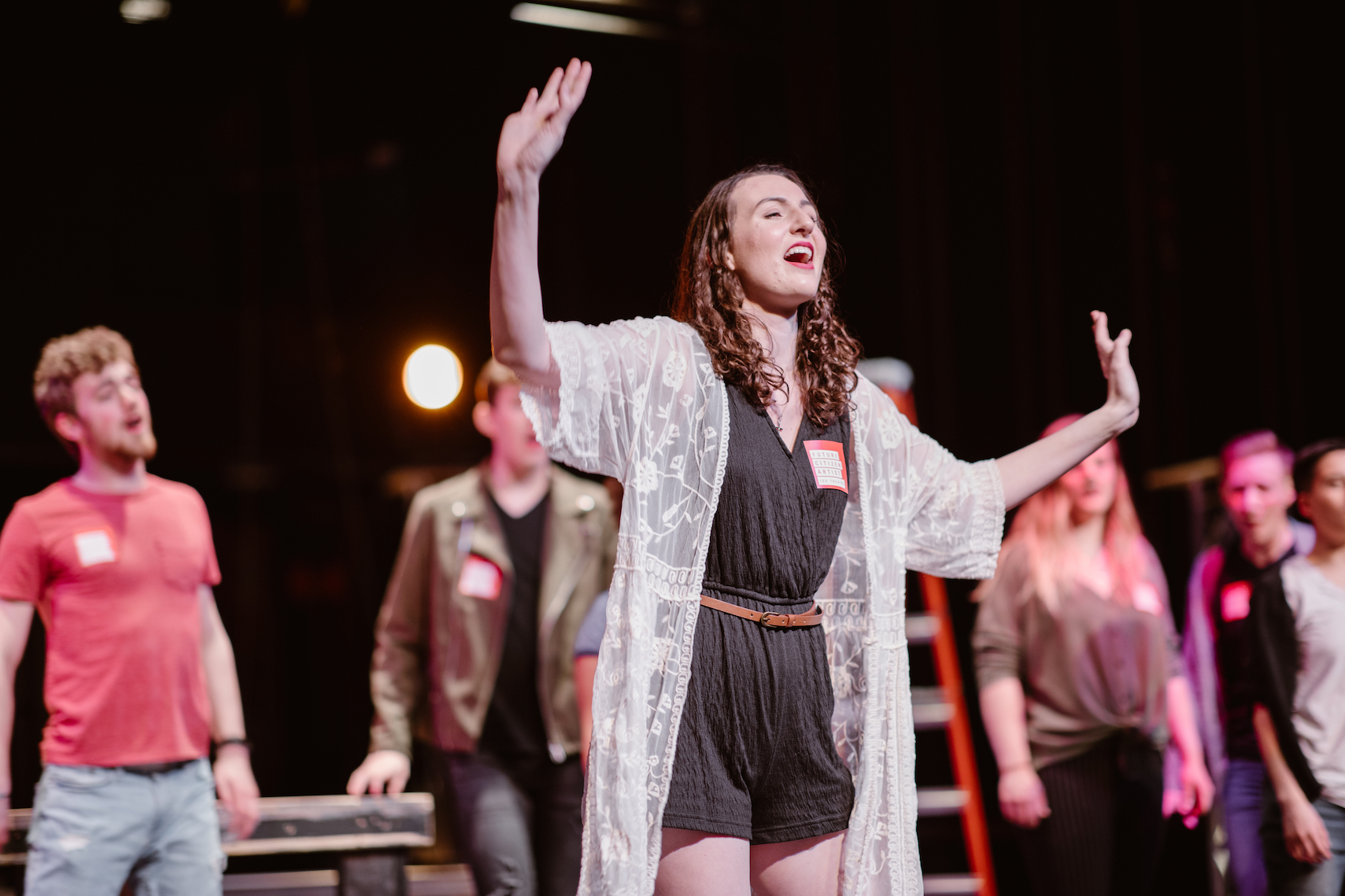 Student singing on stage