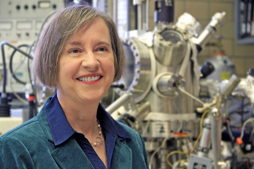 Scientist with lab equipment in background