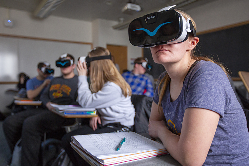 Students in classroom using VR goggles to view Spain.