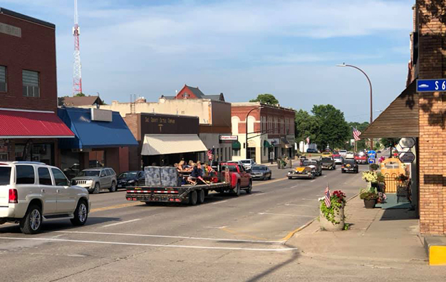 Parade of cars driving down Main Street in Sac City, Iowa