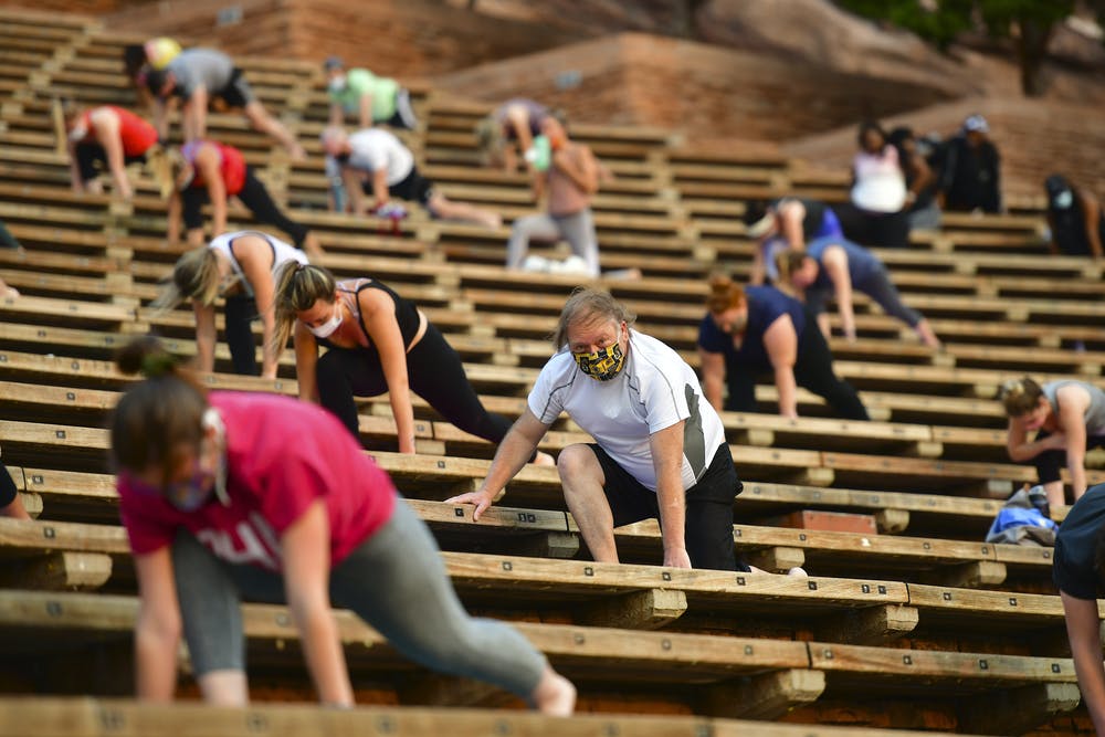 men and women participate in an outdoor exercise class