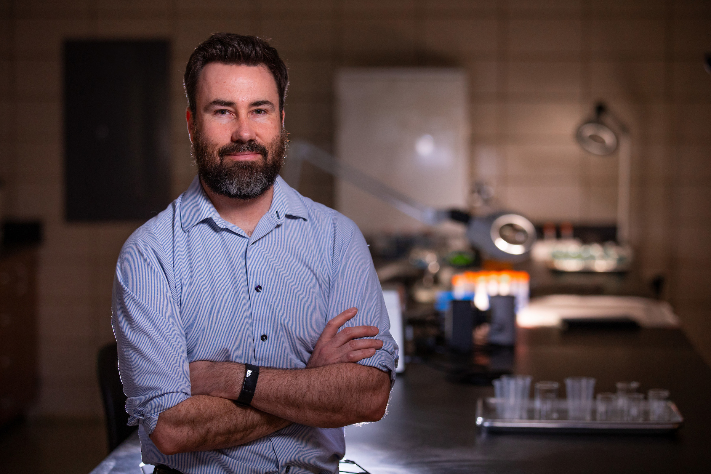 Andrew Somerville stands in his research lab