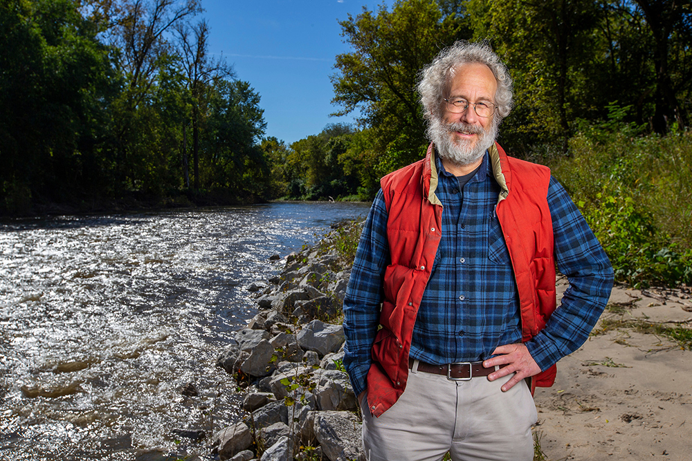 William Gustowski poses by a creek