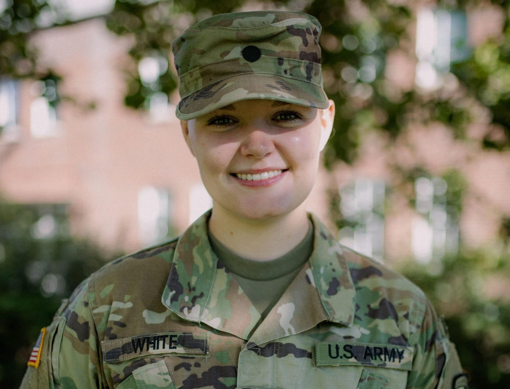 Kennedy White, a criminal justice major, poses outside in her military fatigues