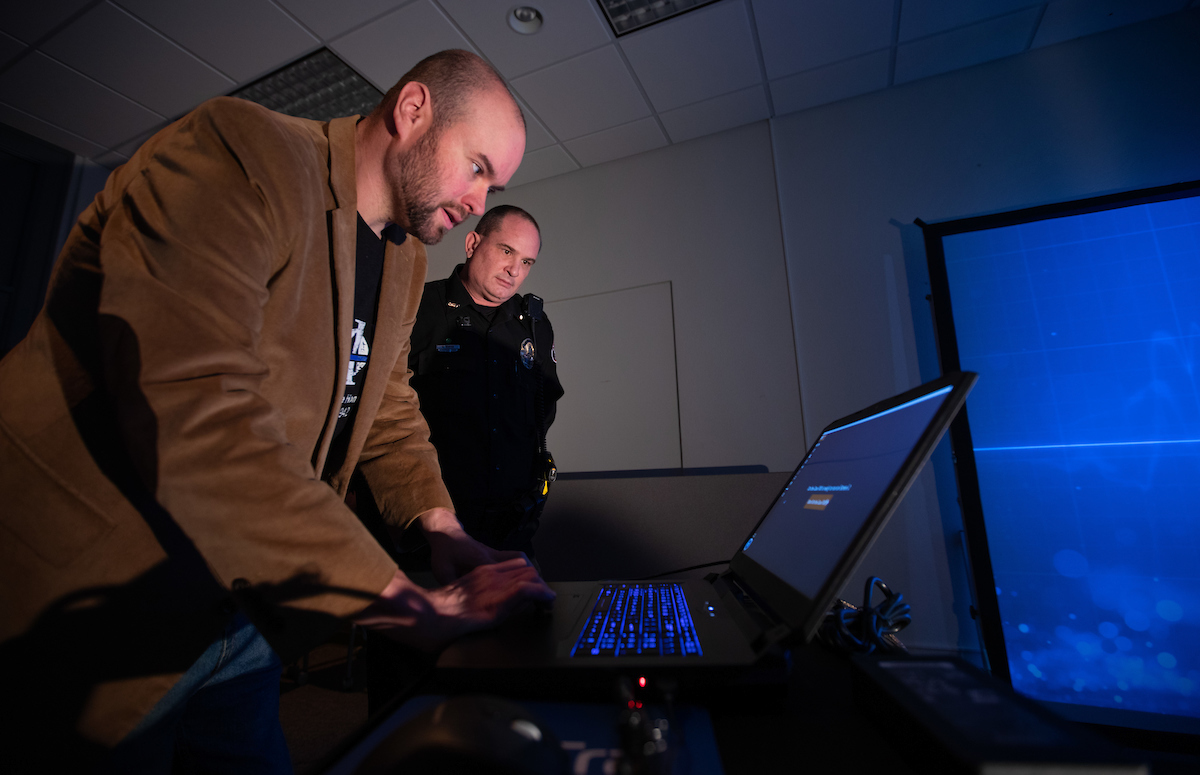 Kyle Burgason and ISU Police Chief Michael Newton set up a computer simulator