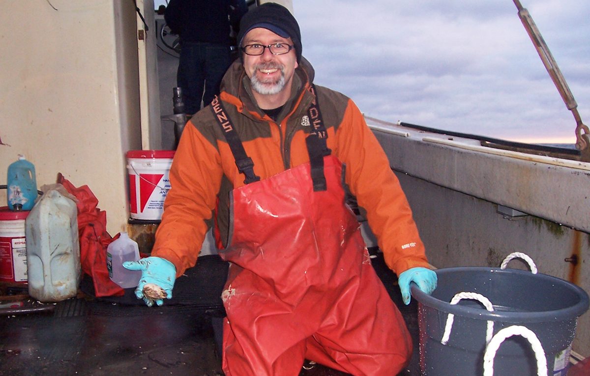 Alan Wanamaker collects clam shells from the Gulf of Maine.