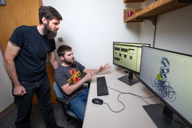 Walter Moss talks with a fellow researcher.