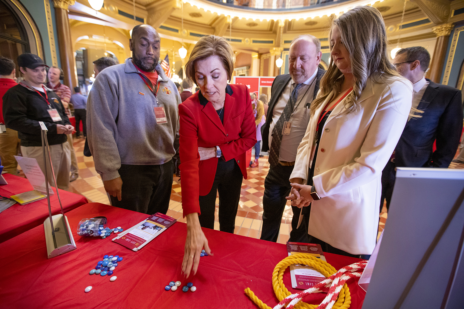 Michael Young shows Gov. Kim Reynolds how to play an interactive math game