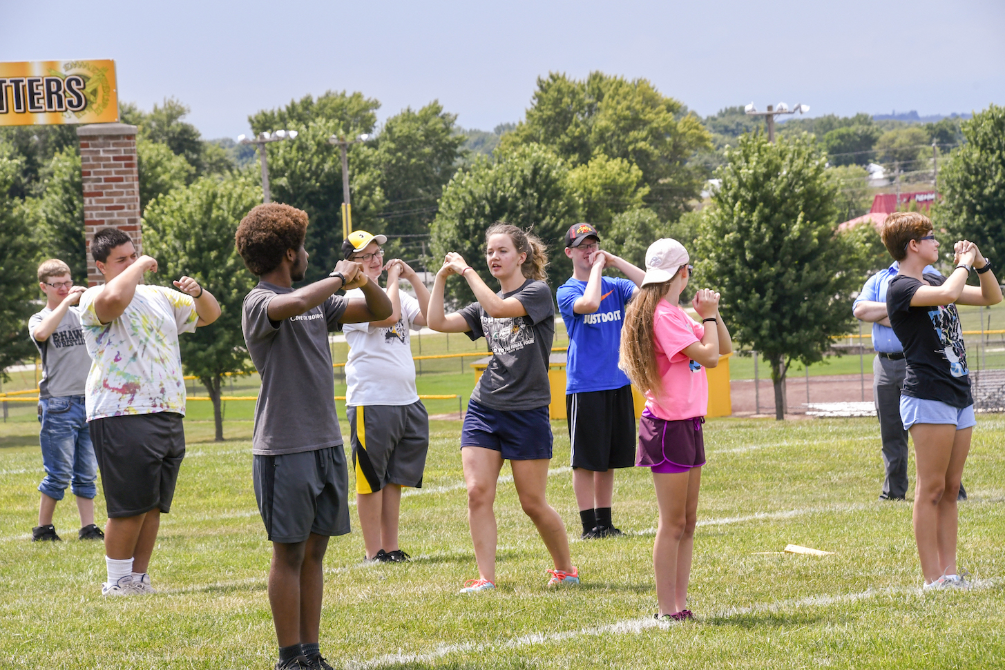 High school marching band practices on a field