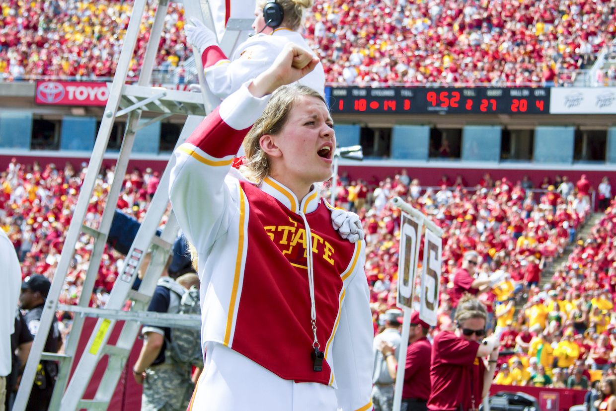 Marching band member shouts instructions on the field