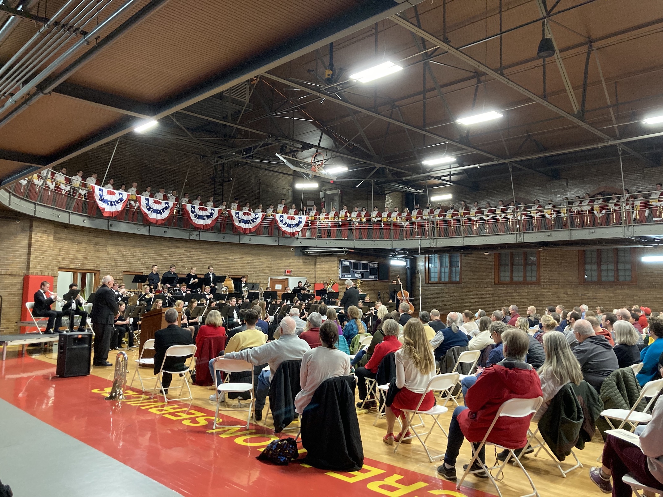 Concert attendees in State Gym listen to a performance by the ISU Wind Ensemble and ISU Marching Band.
