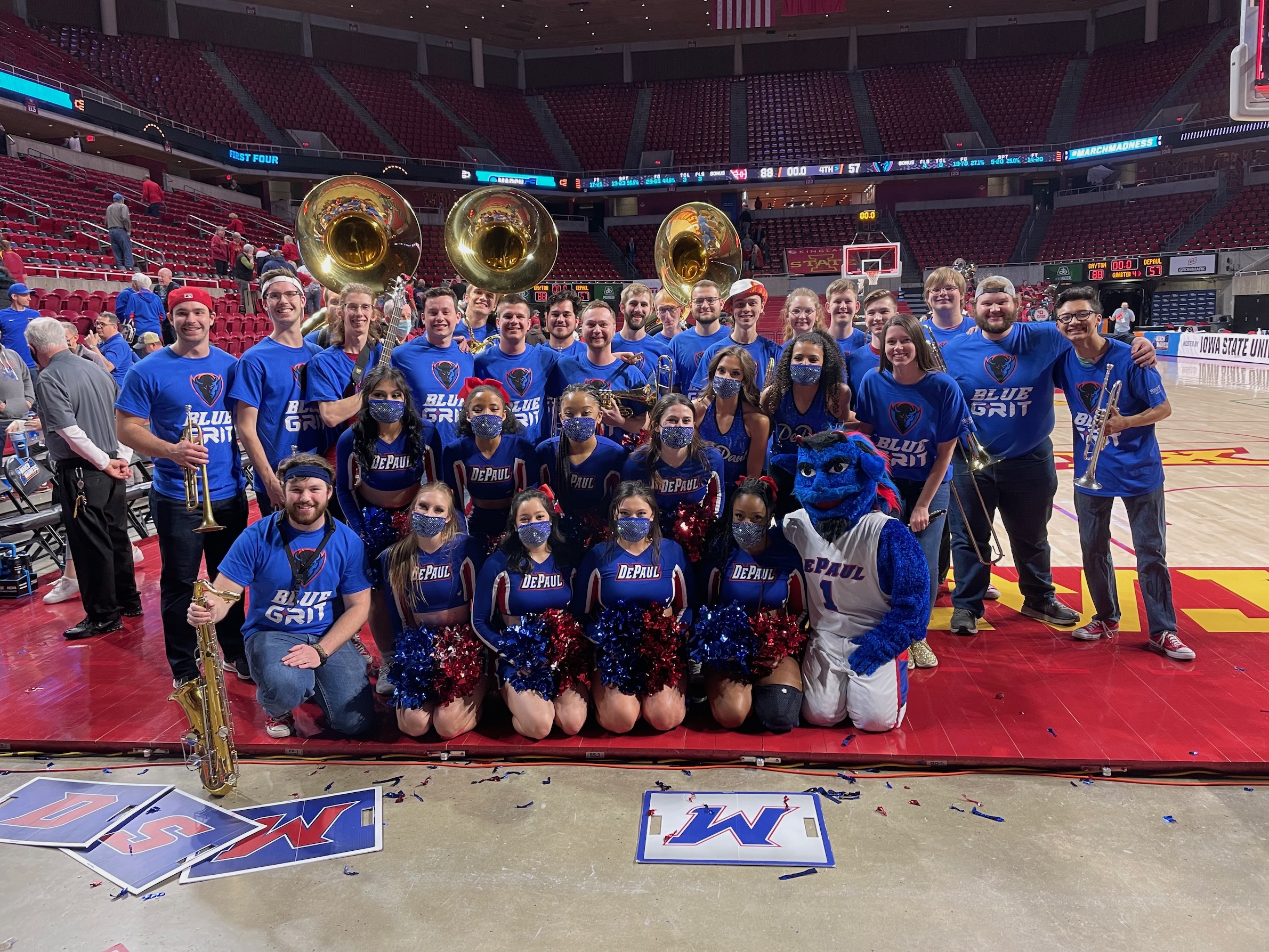 Iowa State pep band members wearing DePaul Blue Demons t-shirts at Hilton Coliseum.