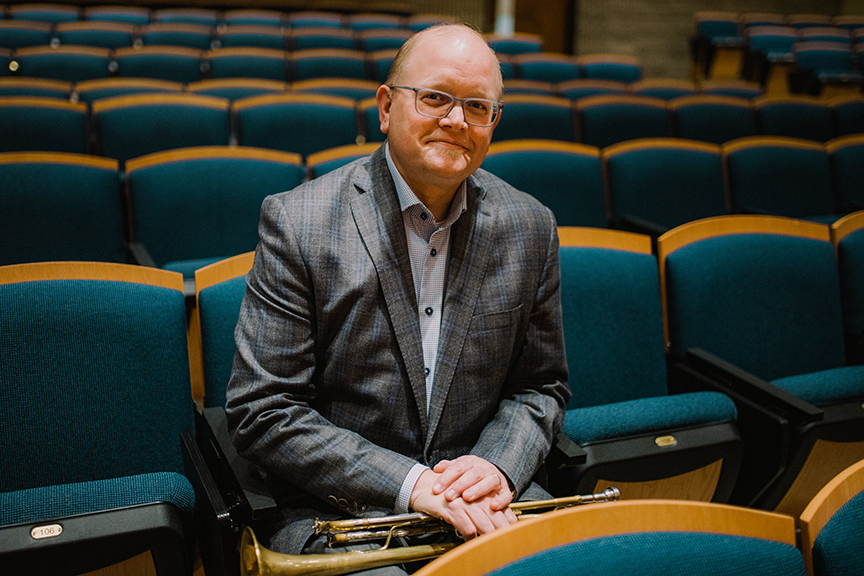 Russ Kramer poses in the auditorium in Simon Estes Music Hall