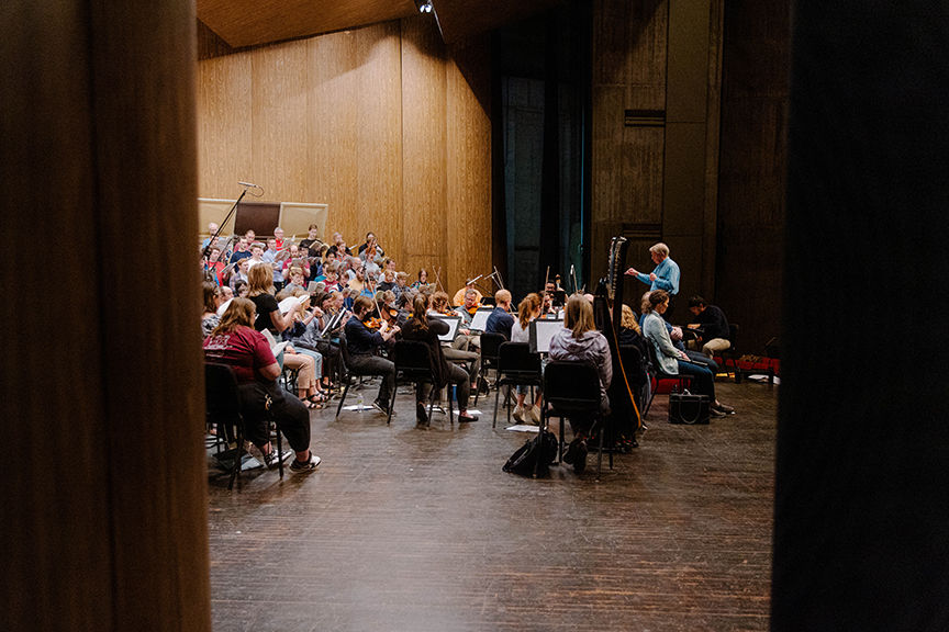Professor of Music James Rodde conducts in Stephens Auditorium during a rehearsal for the ISU Masterworks concert this spring.