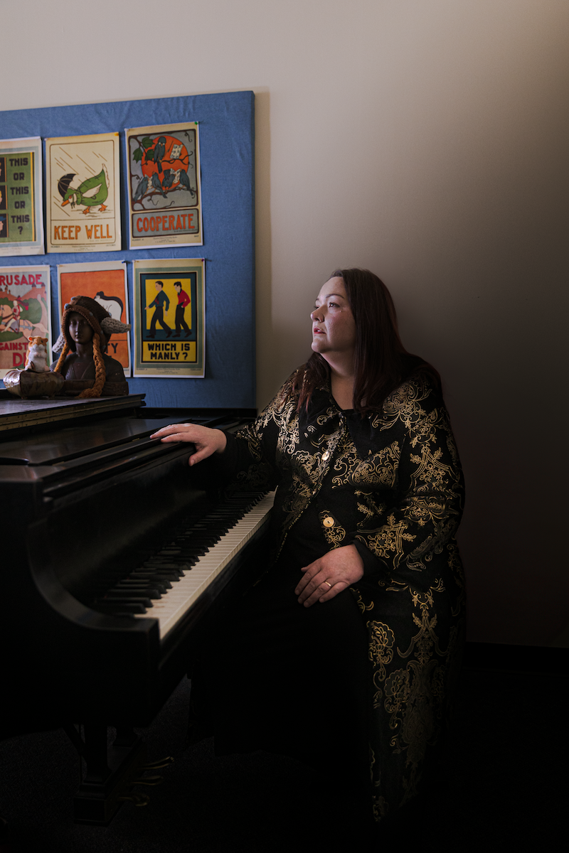 Person seated at piano looks ahead