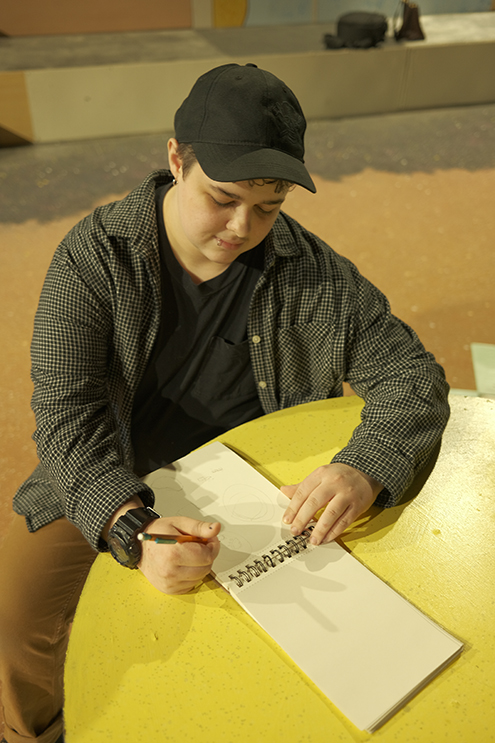 Student draws in blank notebook