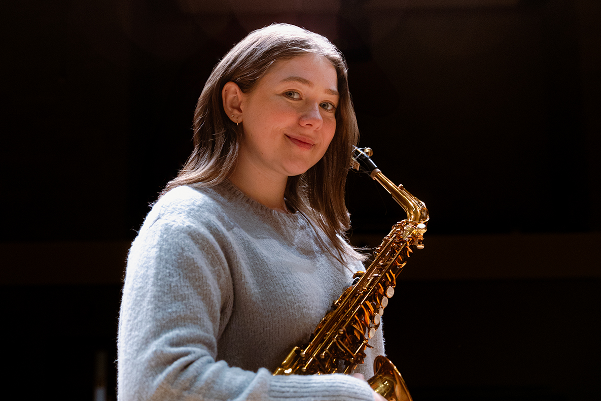 Lydia Linch holds her saxophone at Simon Estes Music Hall
