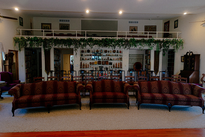Chairs set out in living room with a balcony area above.