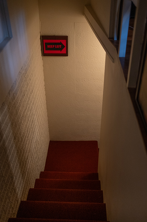 Staircase with sign at the bottom that reads Keep left