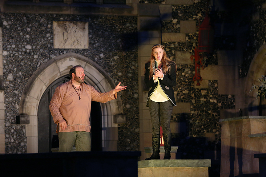 Actors perform Romeo and Juliet scene outdoors in front of historic Salisbury House.