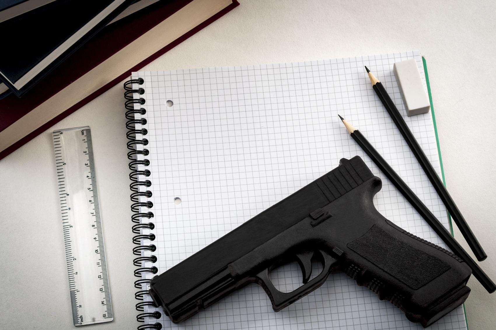 Gun laying atop notebook