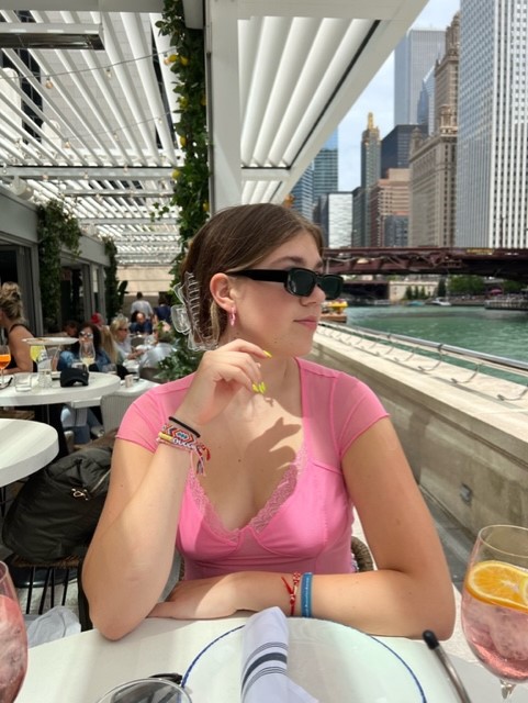 Anna Stultz eating outside near a river
