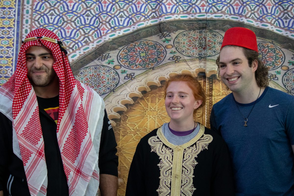 Three students smiling at Arab Night 2024